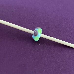 Trollbeads Retired green and purple triangles bead. TGLBE-10060.